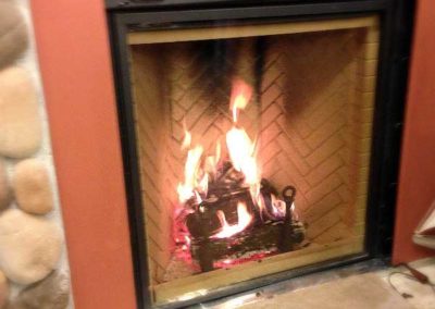 Renaissance Rumford Wood Fireplace with herringbone b rick in firebox and stone surround.